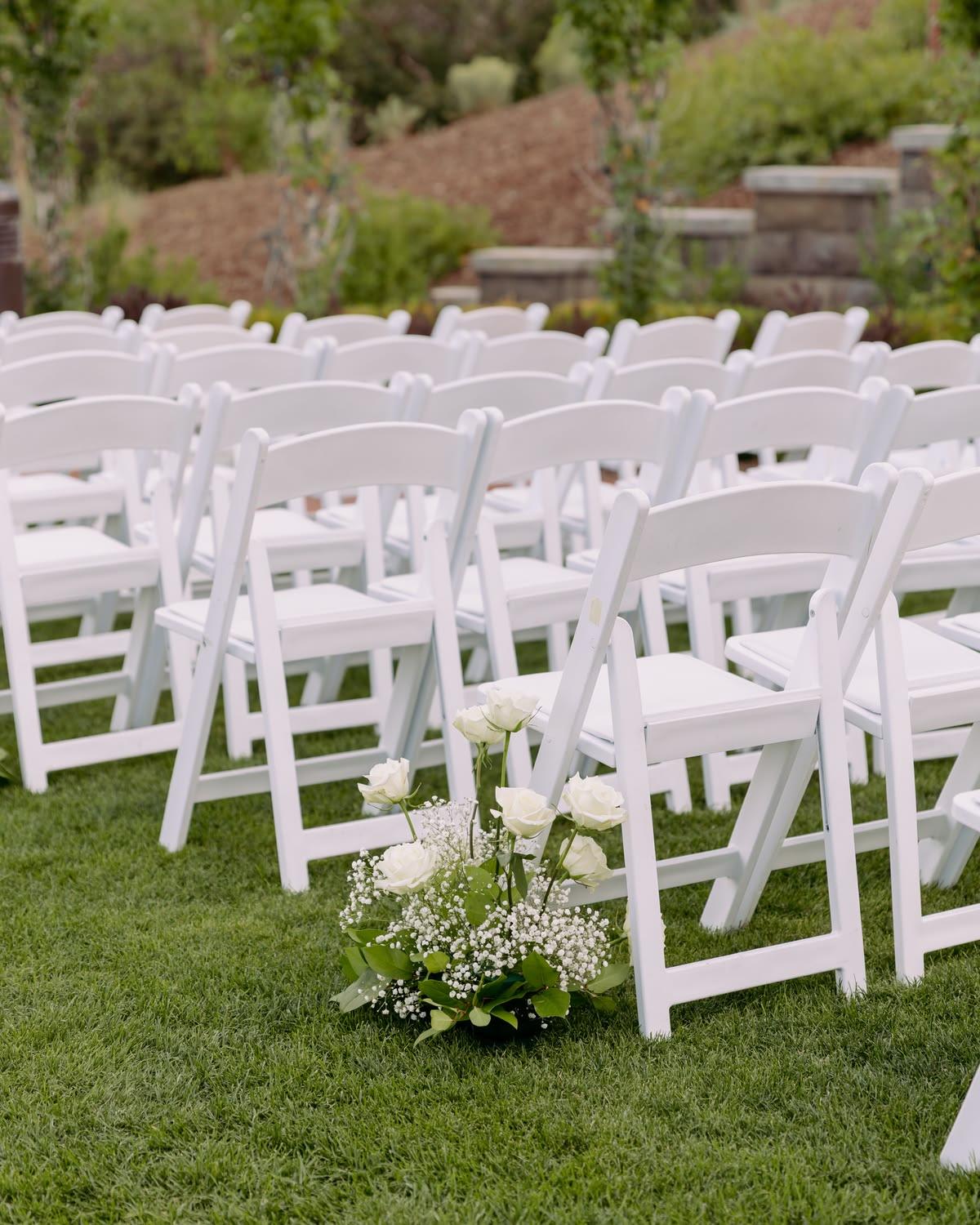 White americana chairs styled at a wedding reception